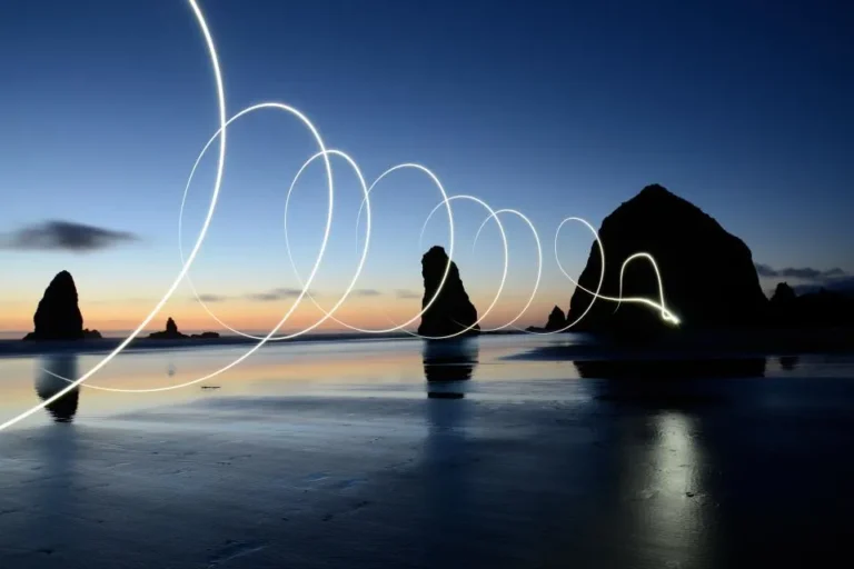 Long exposure light painting over coastal sea stacks